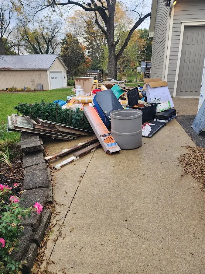 Dumpster being loaded with debris for Demolition Dumpster Rental in Belen